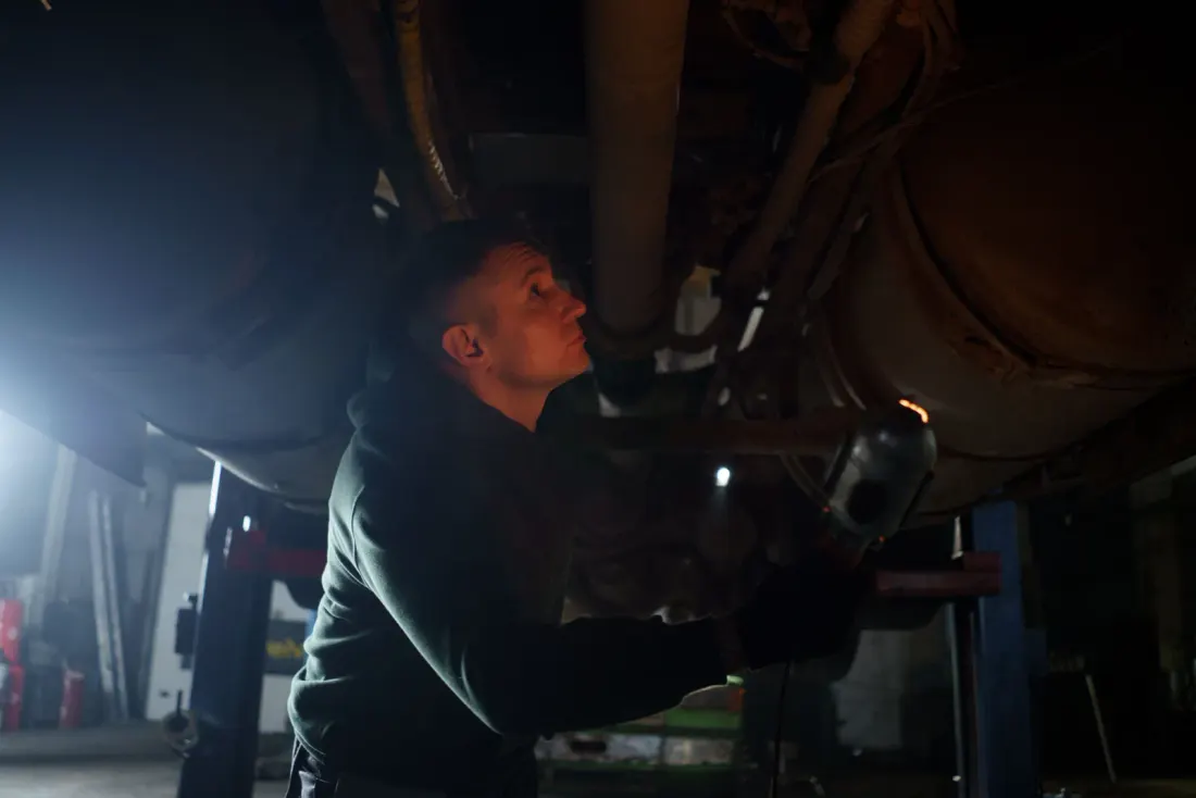Mechanic working under a vehicle